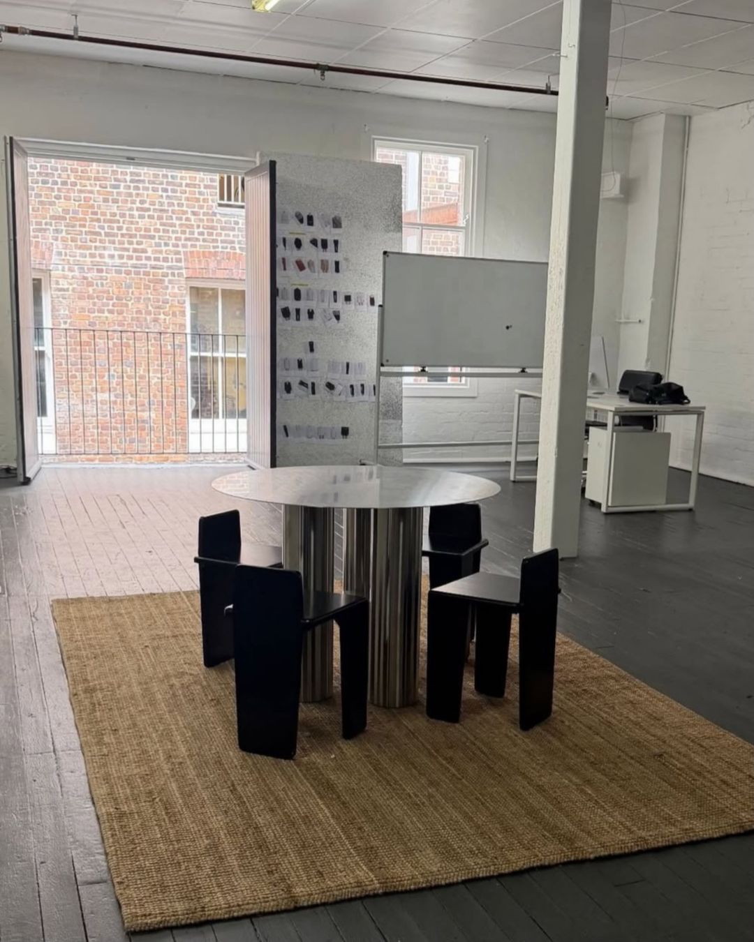 Stainless steel dining table styled in an office