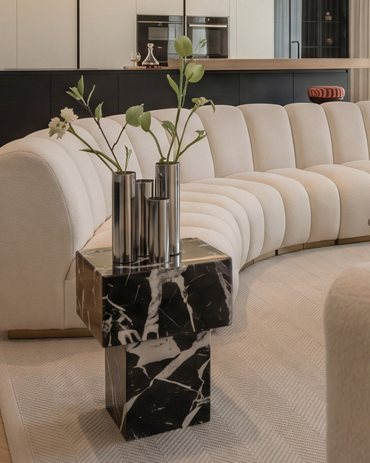 Living room styled with a marble side table and chrome vase