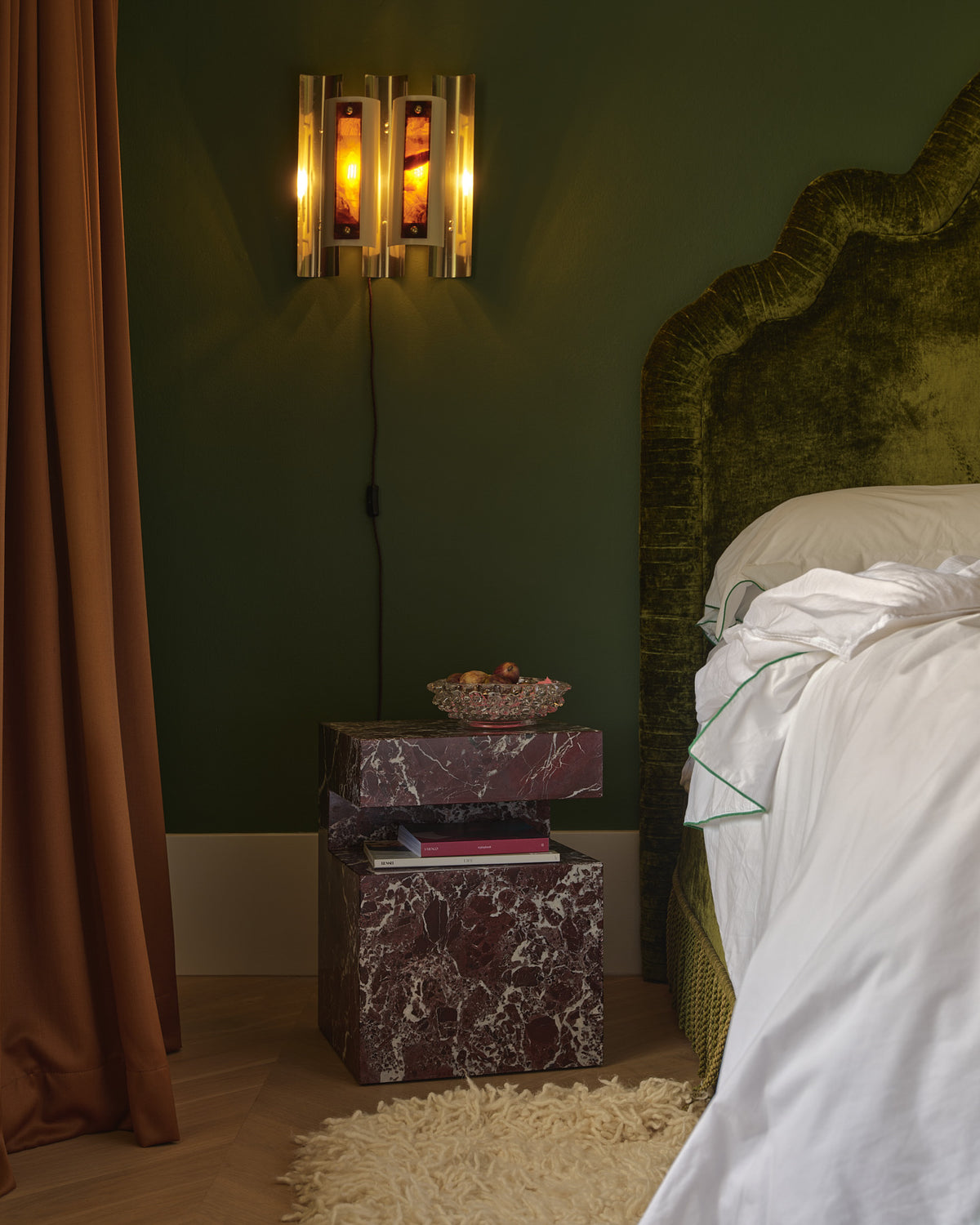 Rosa levanto marble bedside table in a bedroom