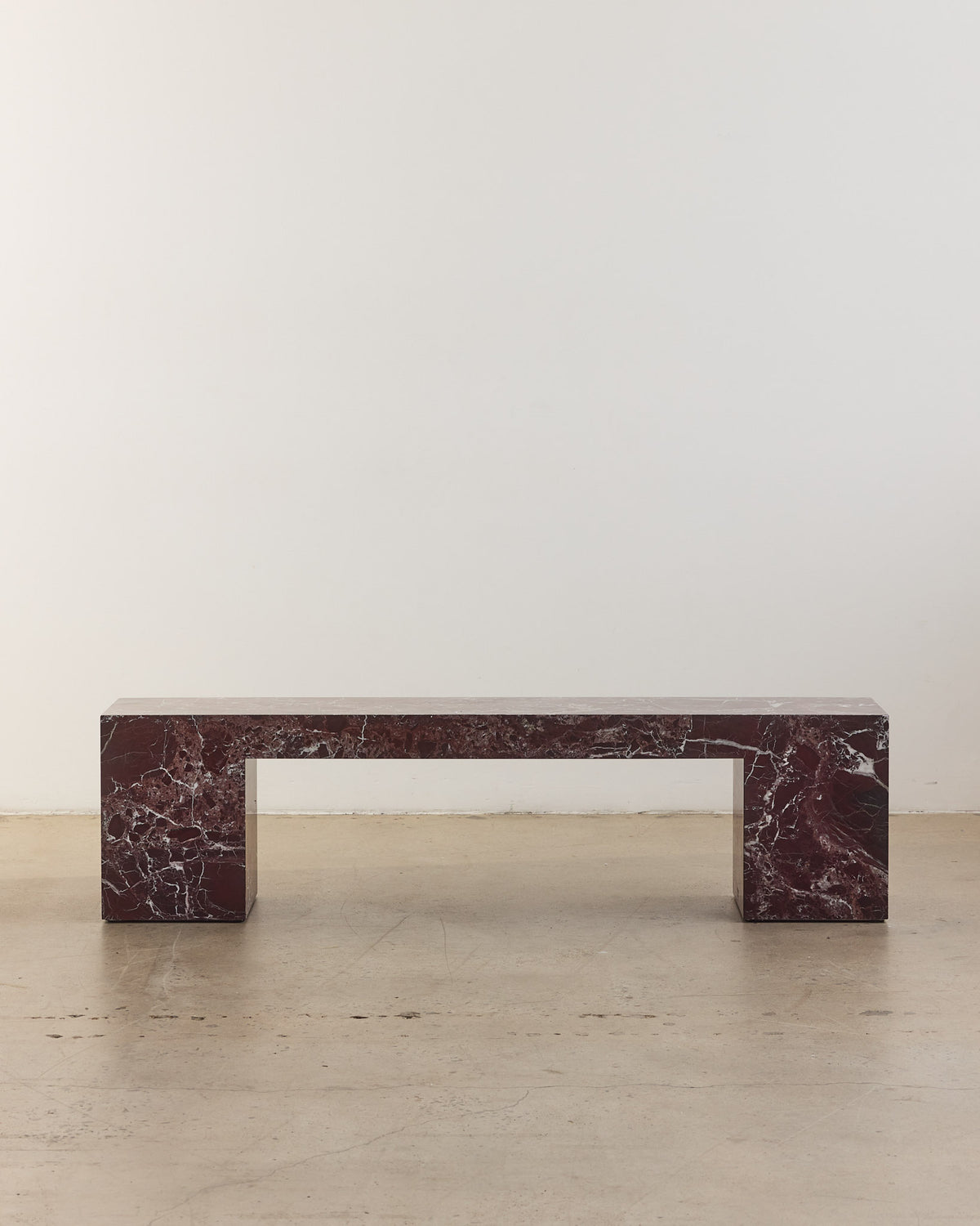 Low marble bench seat in rosa levanto