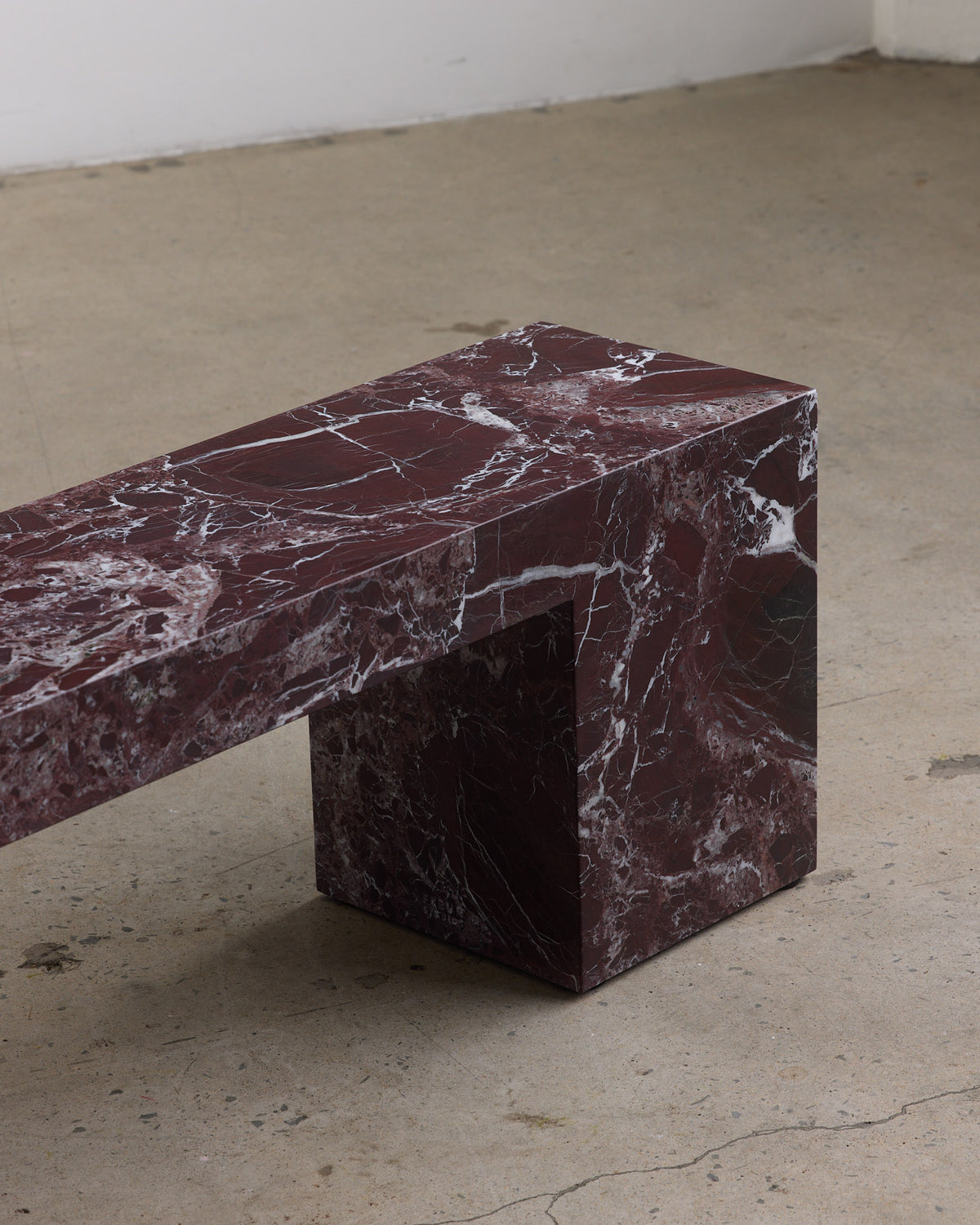 Low marble bench seat in rosa levanto