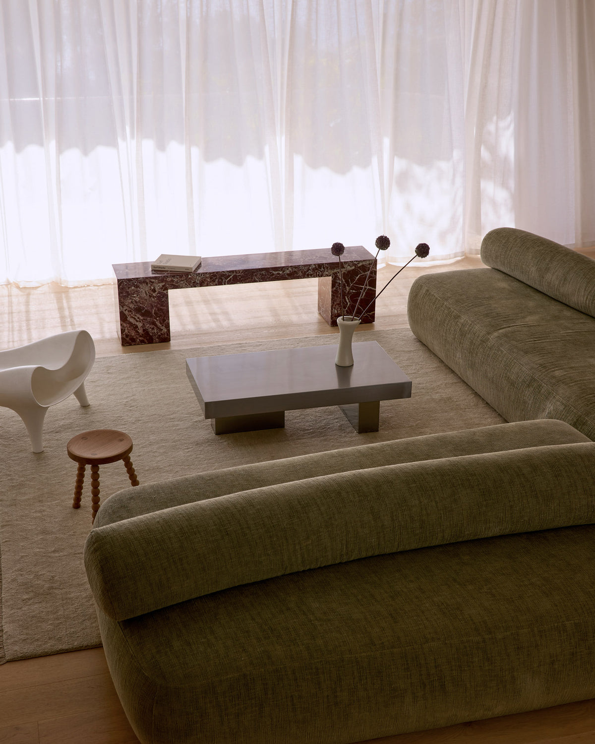 Modern stainless steel coffee table styled in a living room.