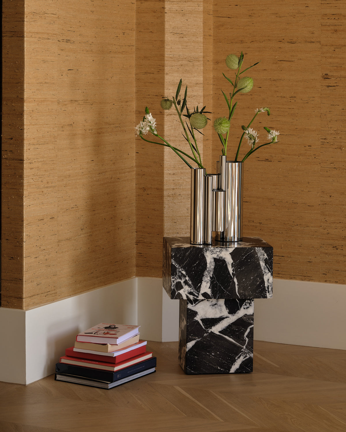 Stainless steel vase styled on a side table
