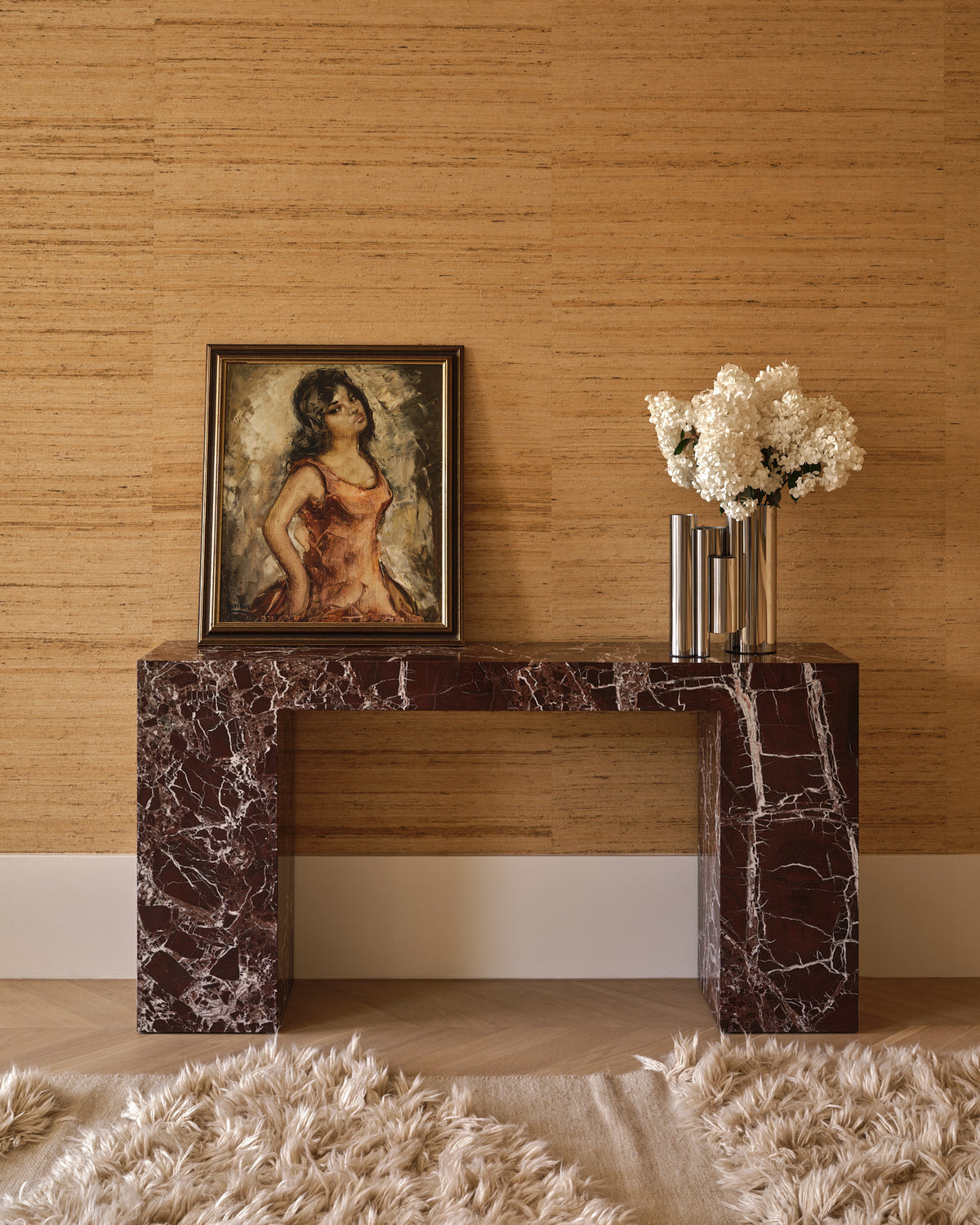 Stainless steel vase styled on a console table