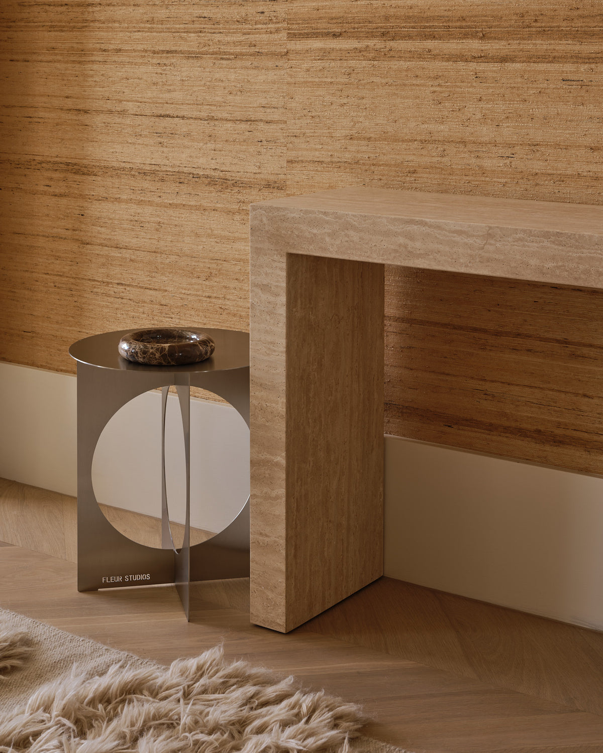 Modern stainless steel side table styled in a home.