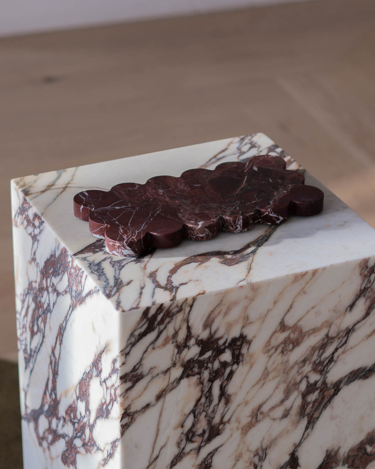Decorative marble plate atop a plinth