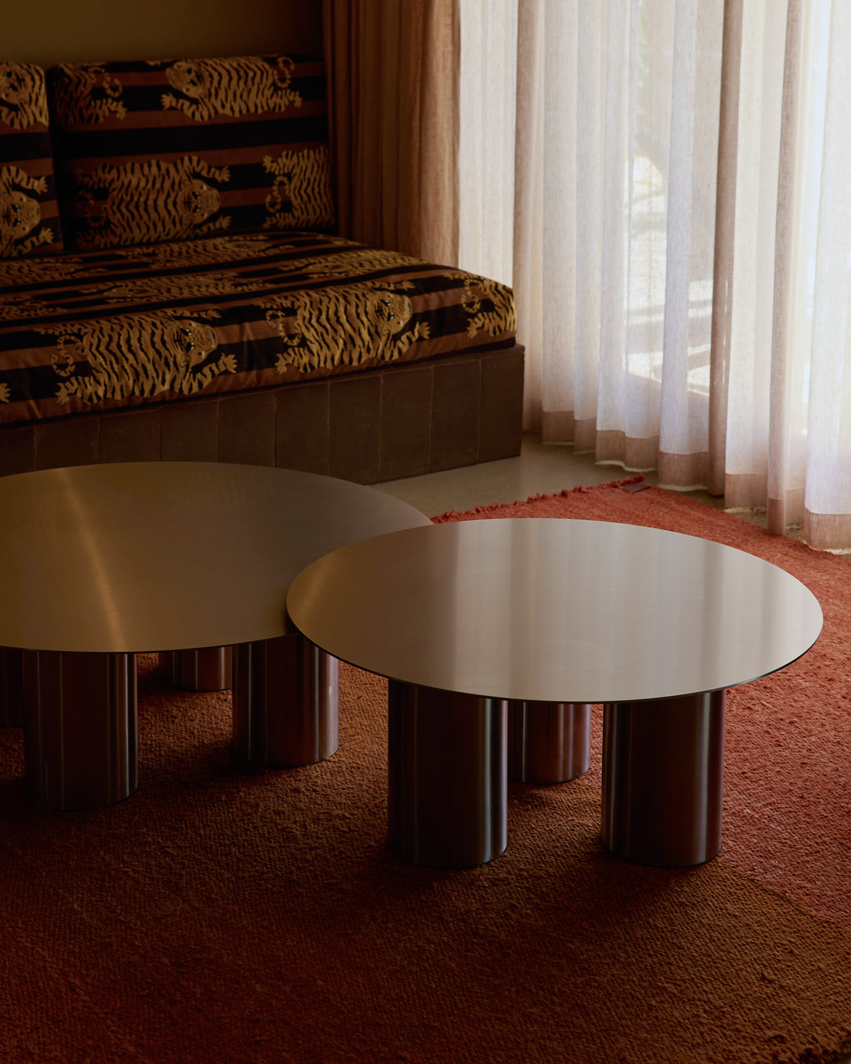 Stainless steel coffee tables styled in a living room.