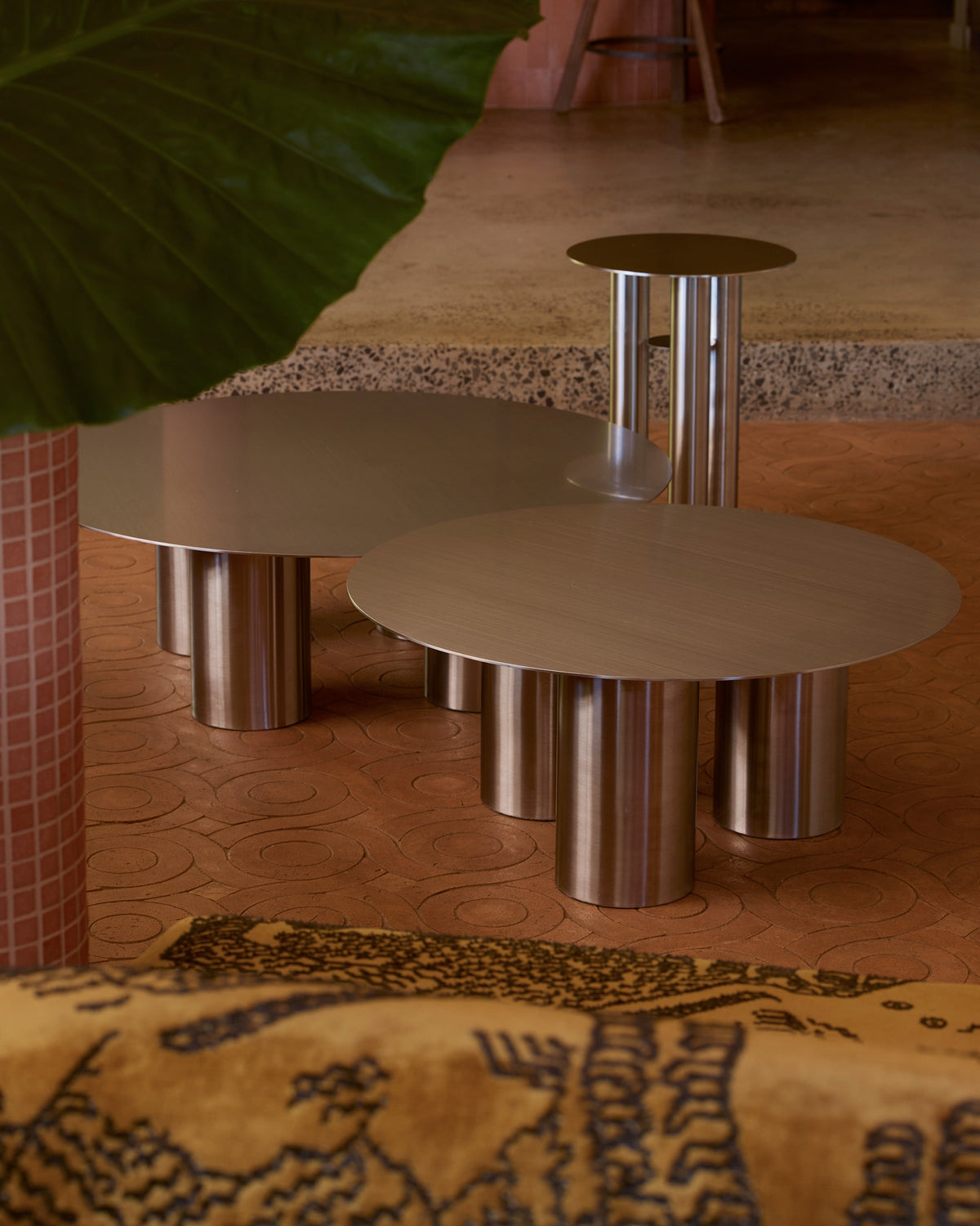Stainless steel coffee tables styled in a living room.