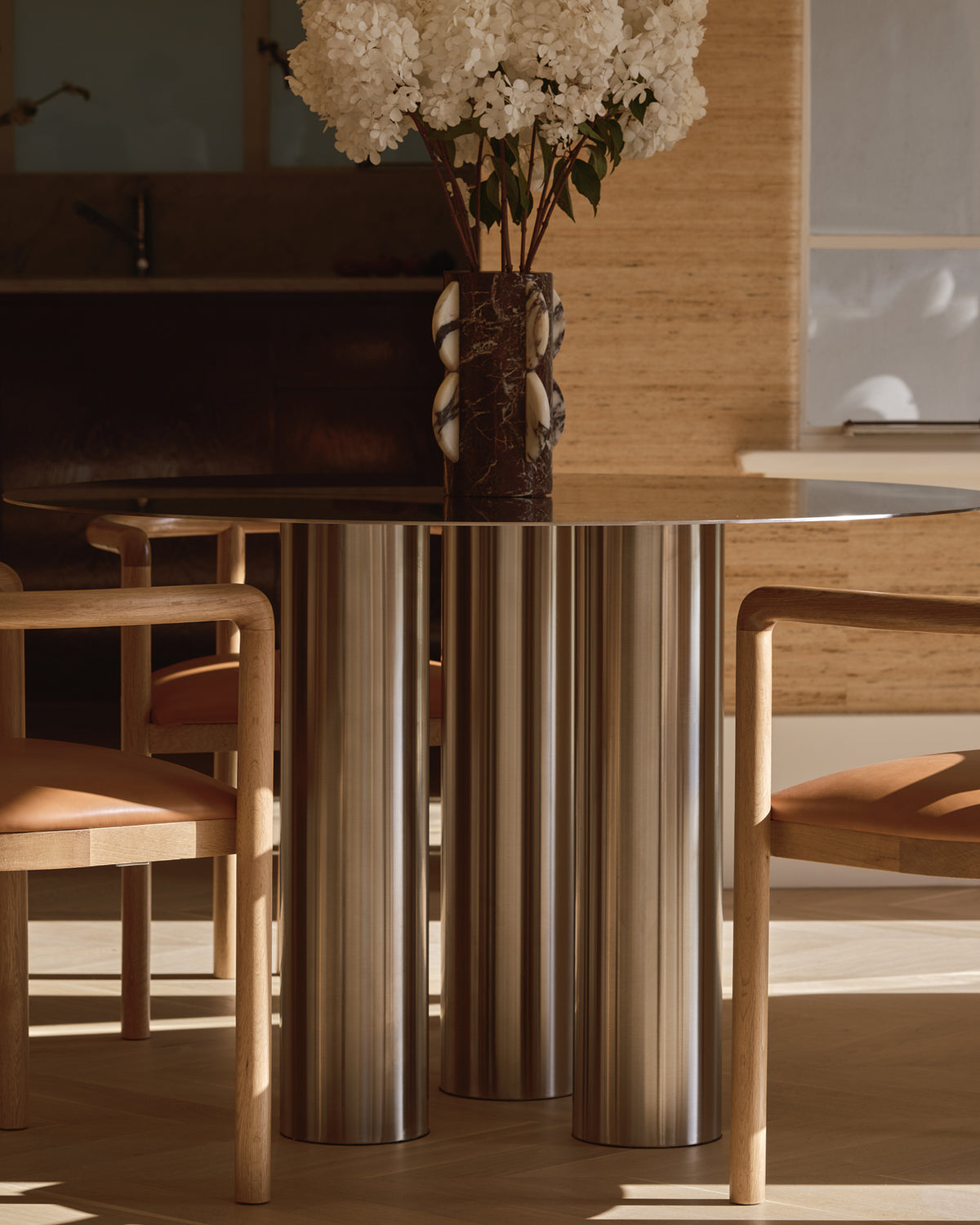 Stainless steel dining table styled in a home.