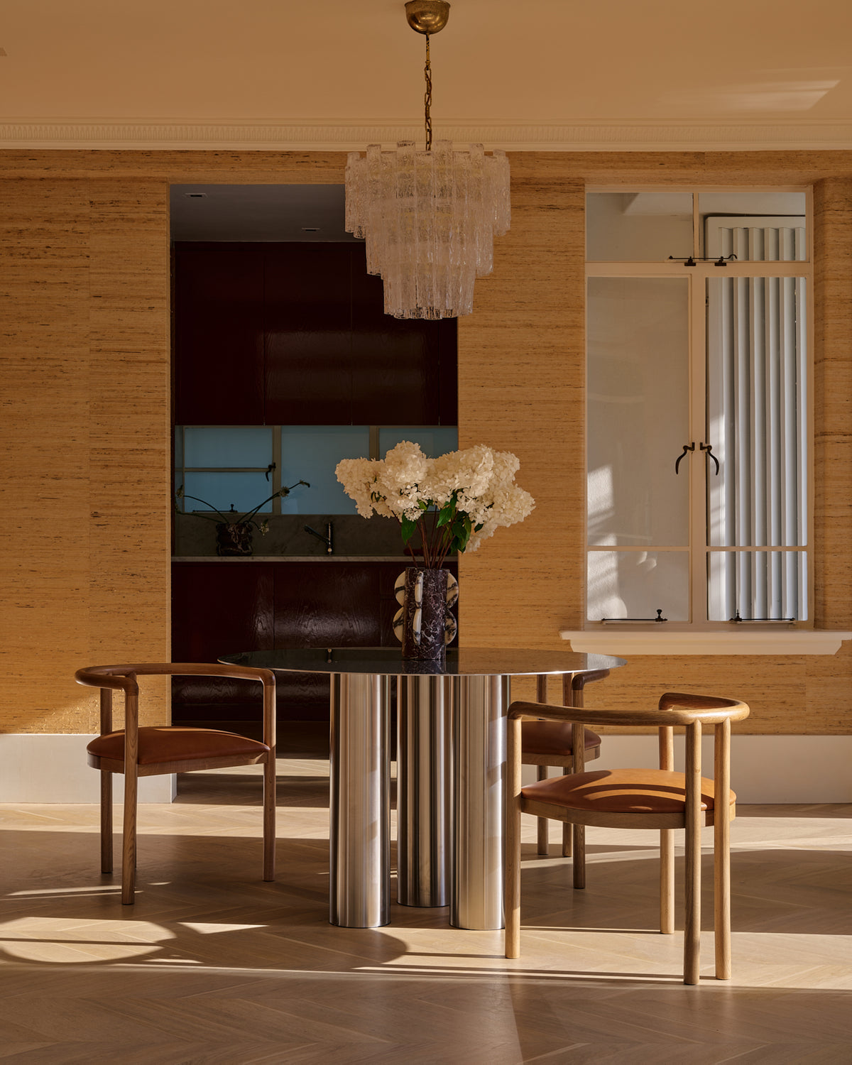 Stainless steel dining table styled in a home.