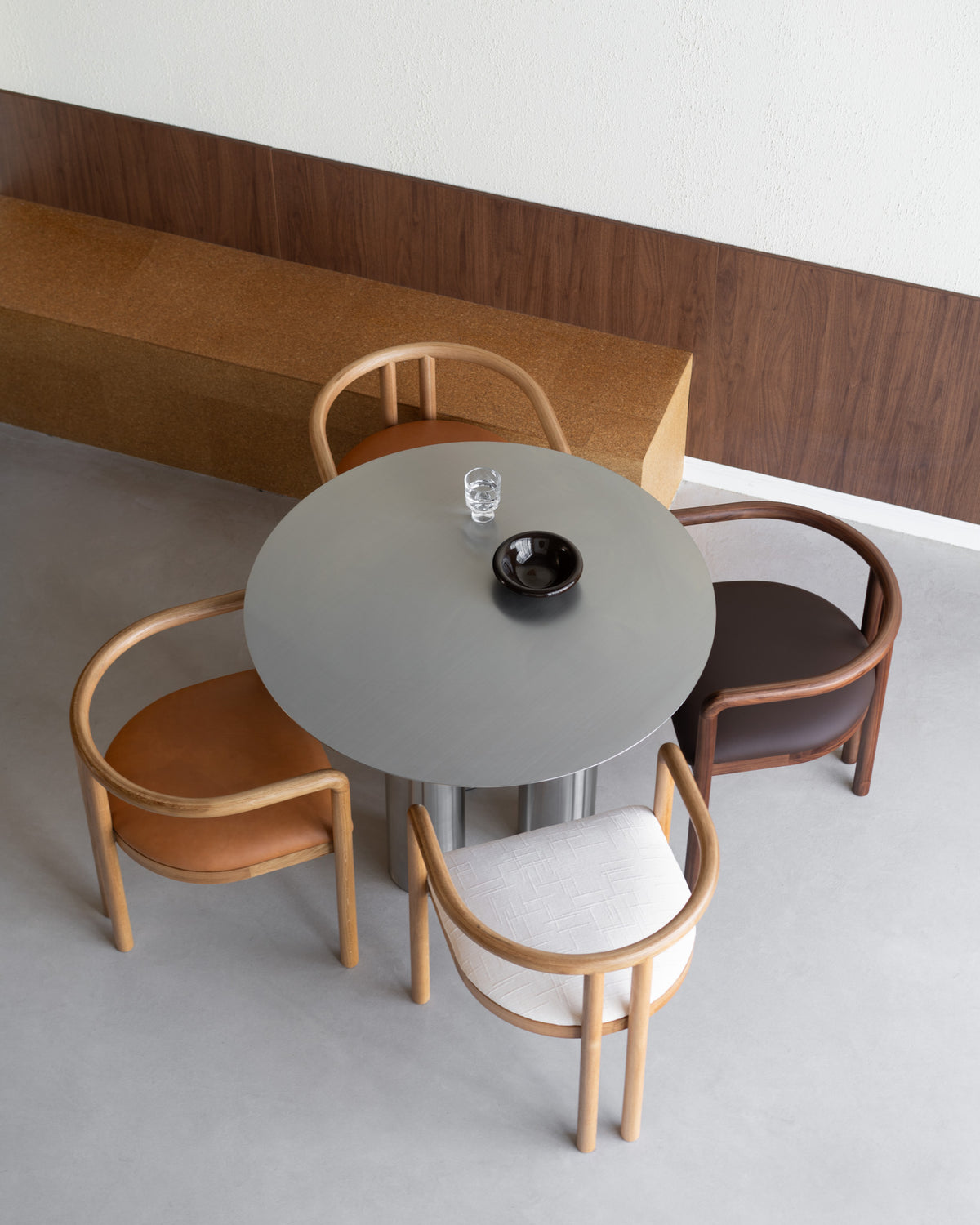 Stainless steel dining table with four dining chairs.