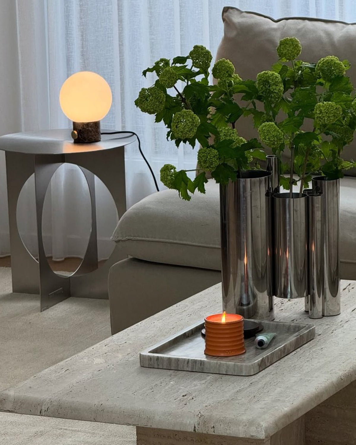 Living room styled with chrome vase