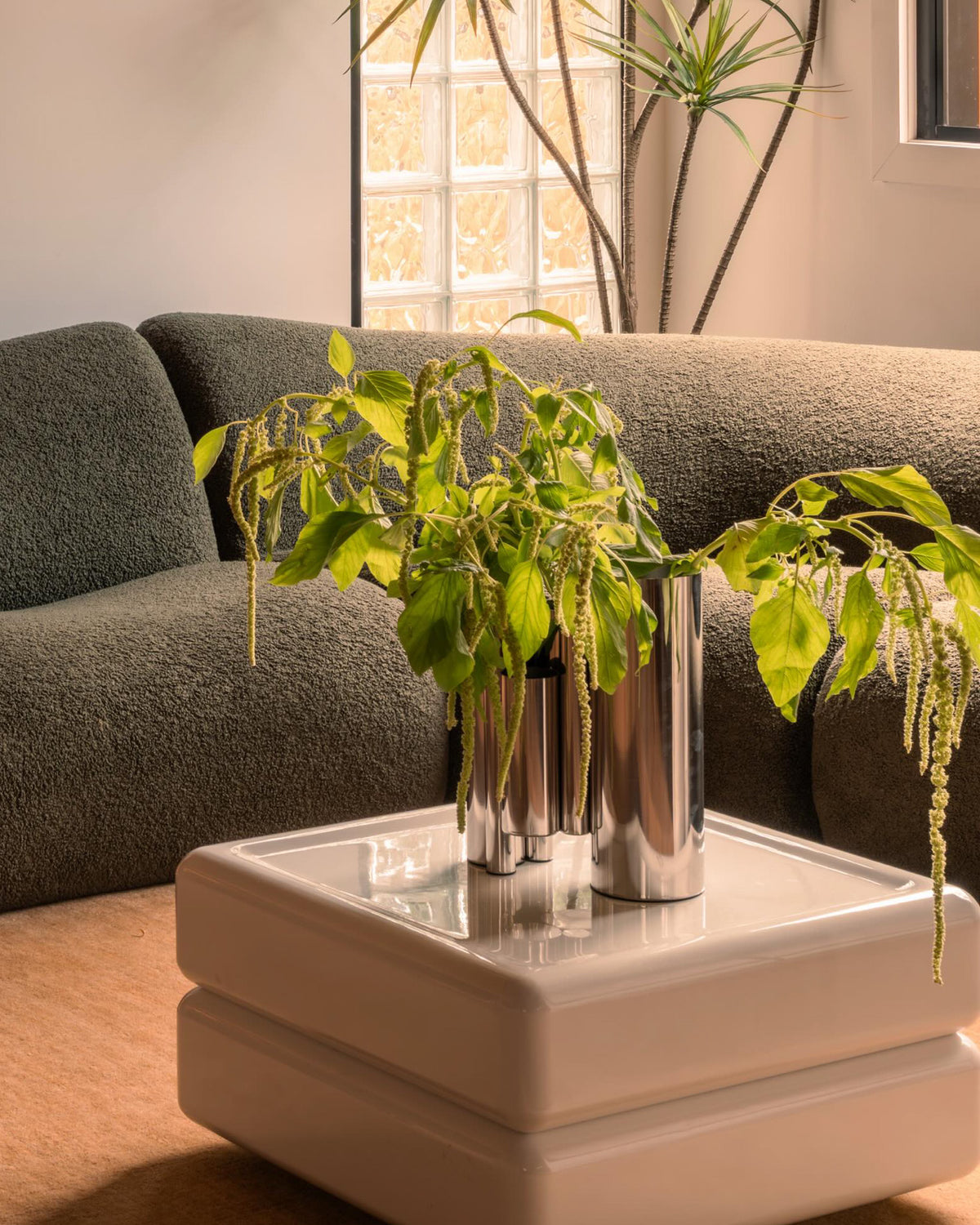 Living room styled with a stainless steel vase