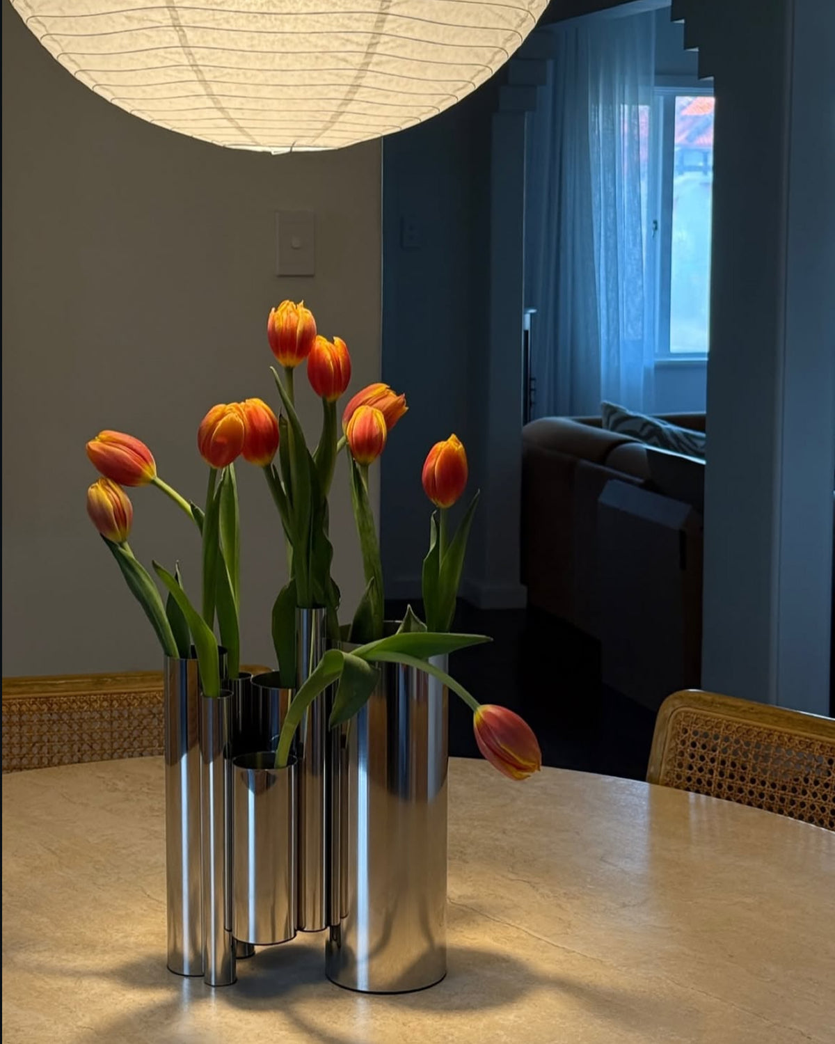 Dining table styled with chrome vase