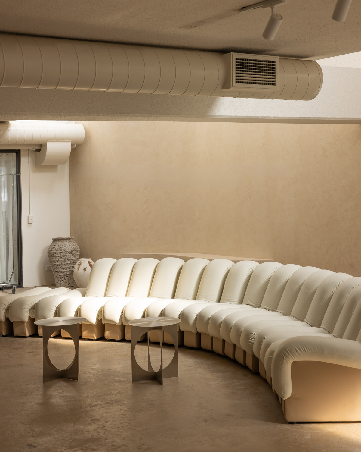 Curved sofa styled with stainless steel side tables