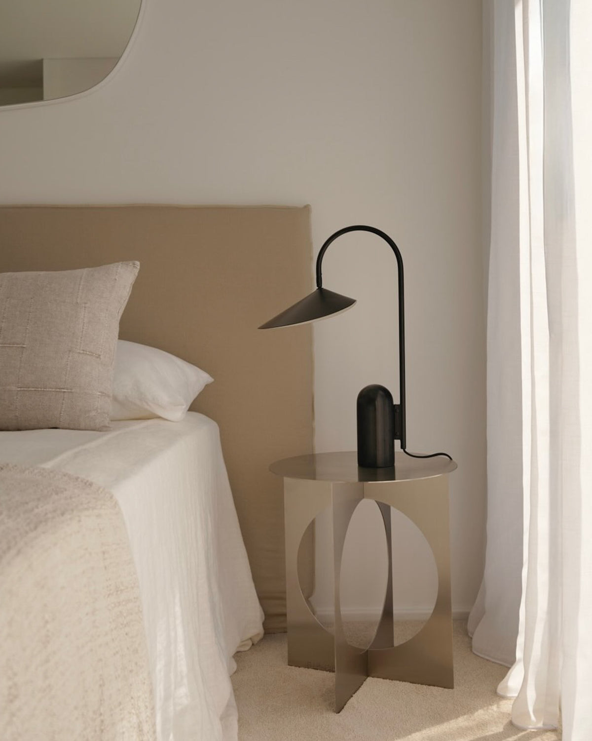 Stainless steel bedside table next to a bed