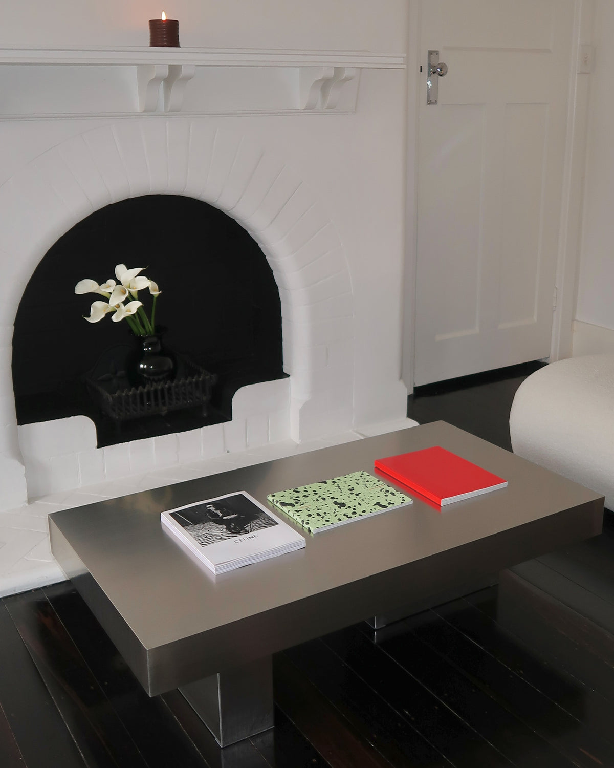 Modern stainless steel coffee table styled in a living room.