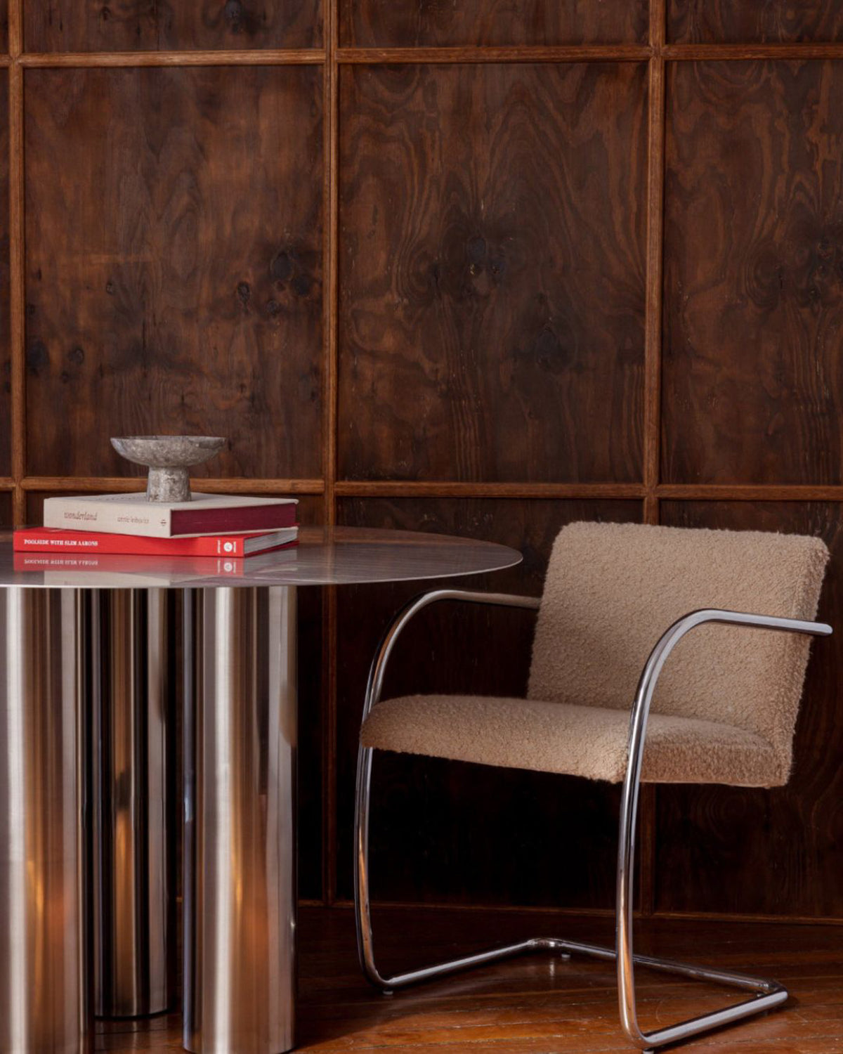 Beige chair next to a round stainless steel table