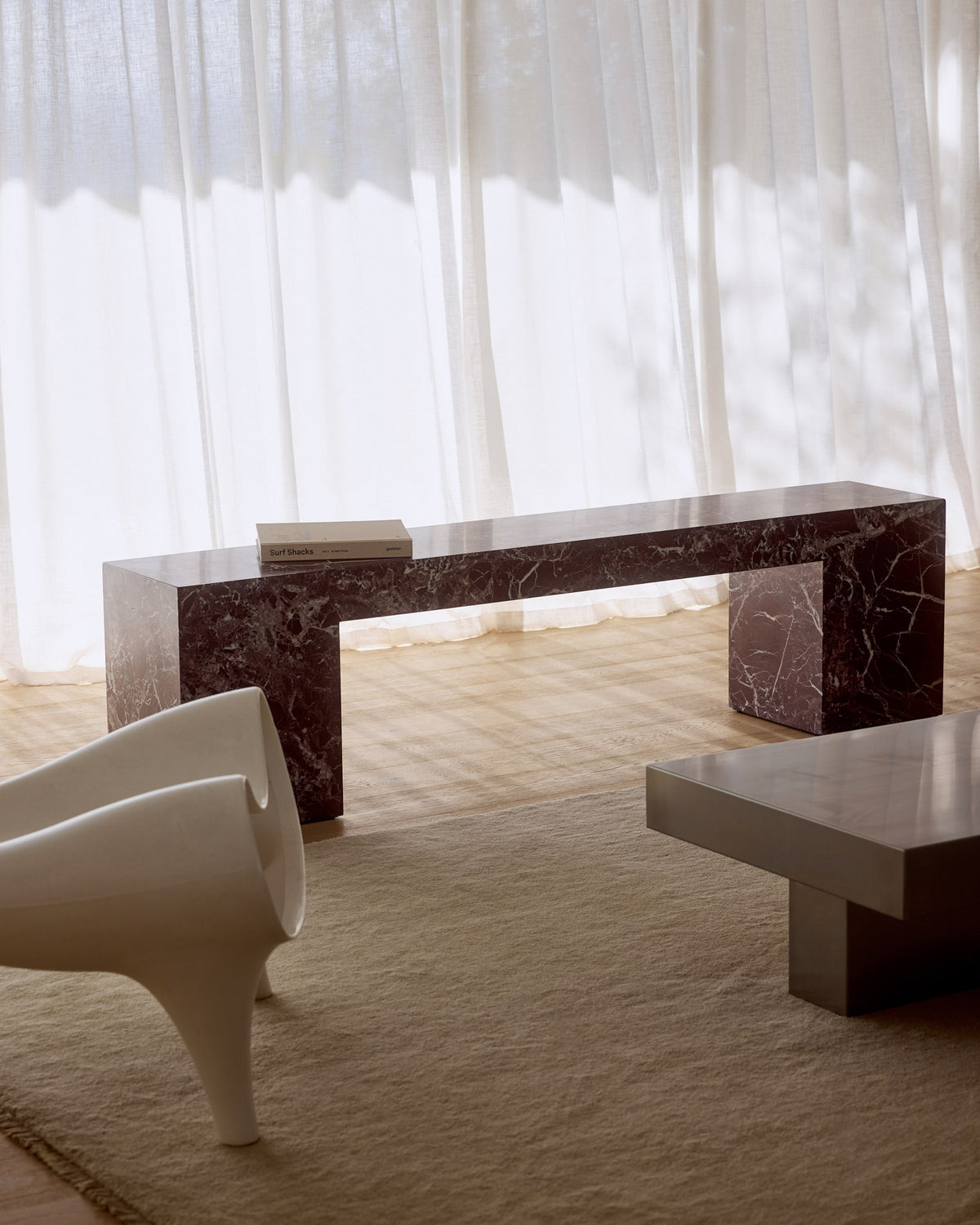 Low marble bench seat in rosa levanto