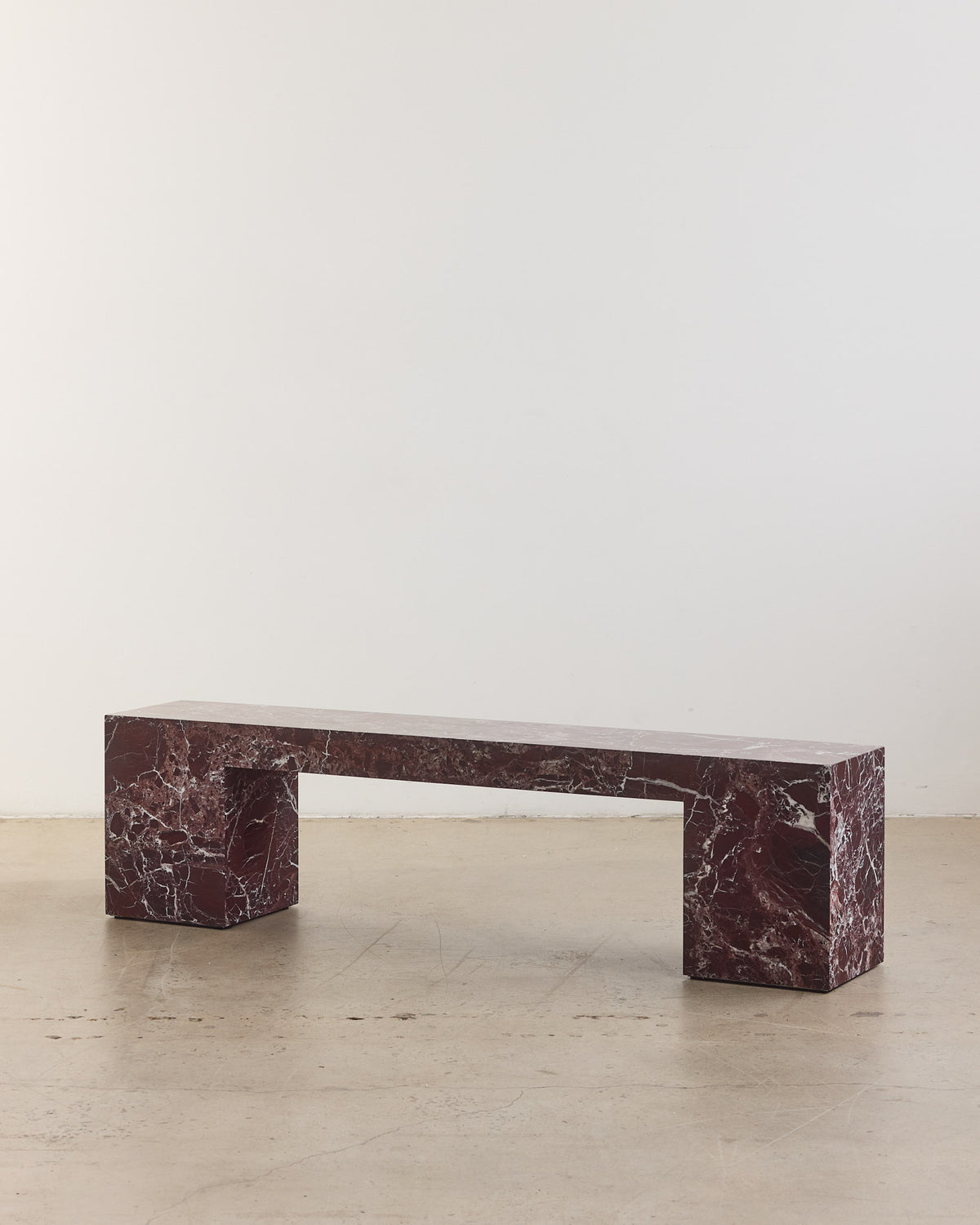 Low marble bench seat in rosa levanto