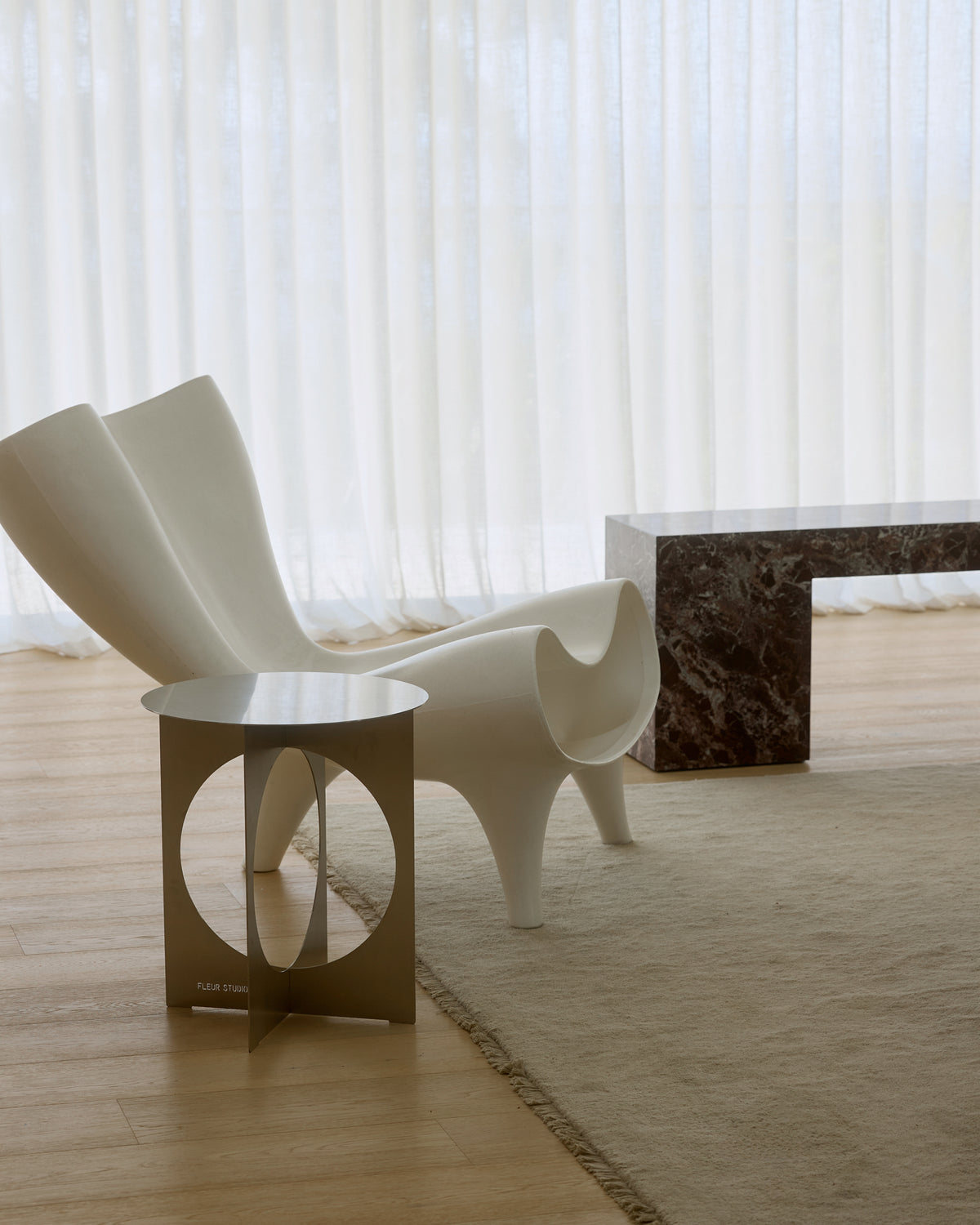 Modern stainless steel side table styled in a home.