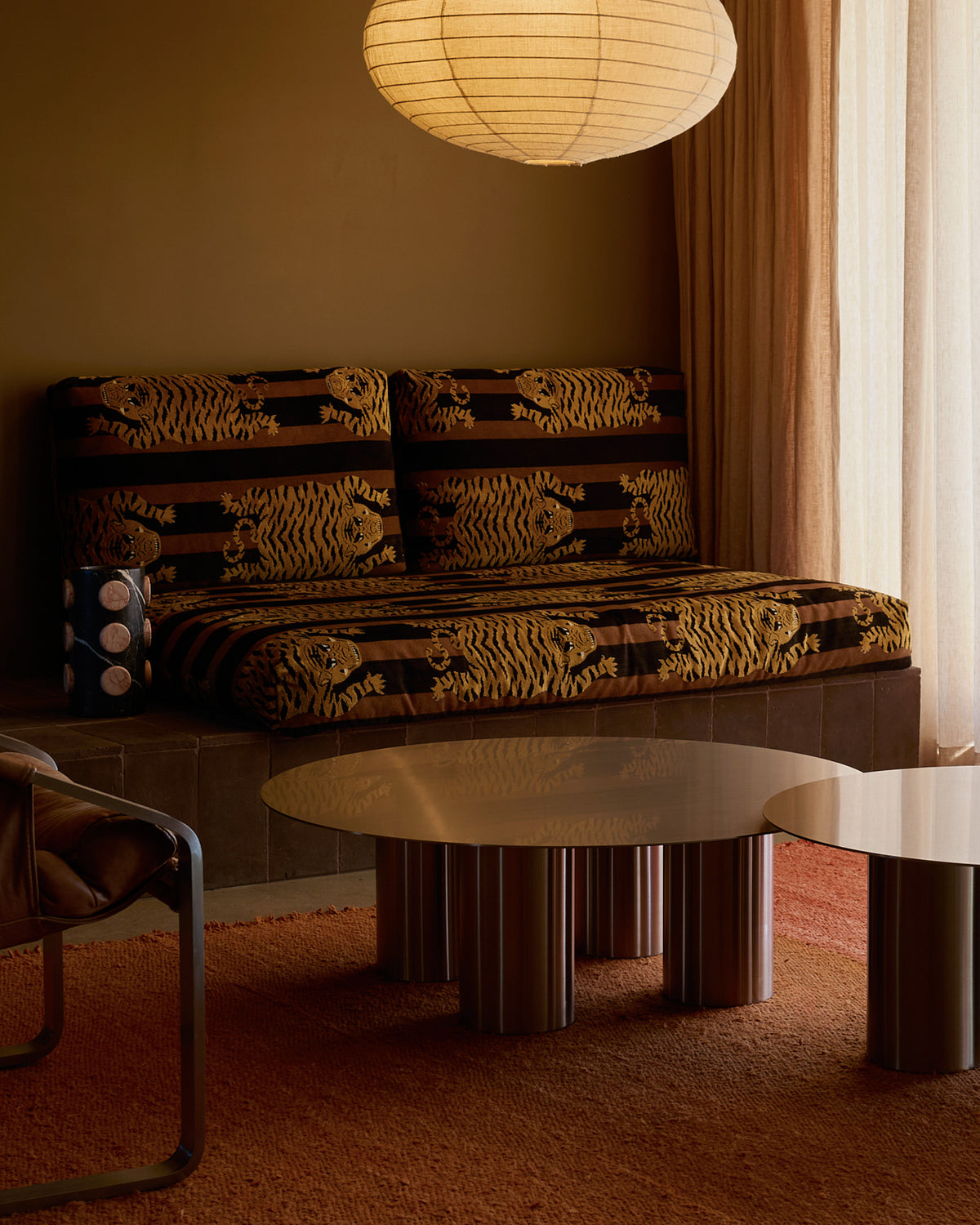 Living room with a patterned sofa and stainless steel coffee table