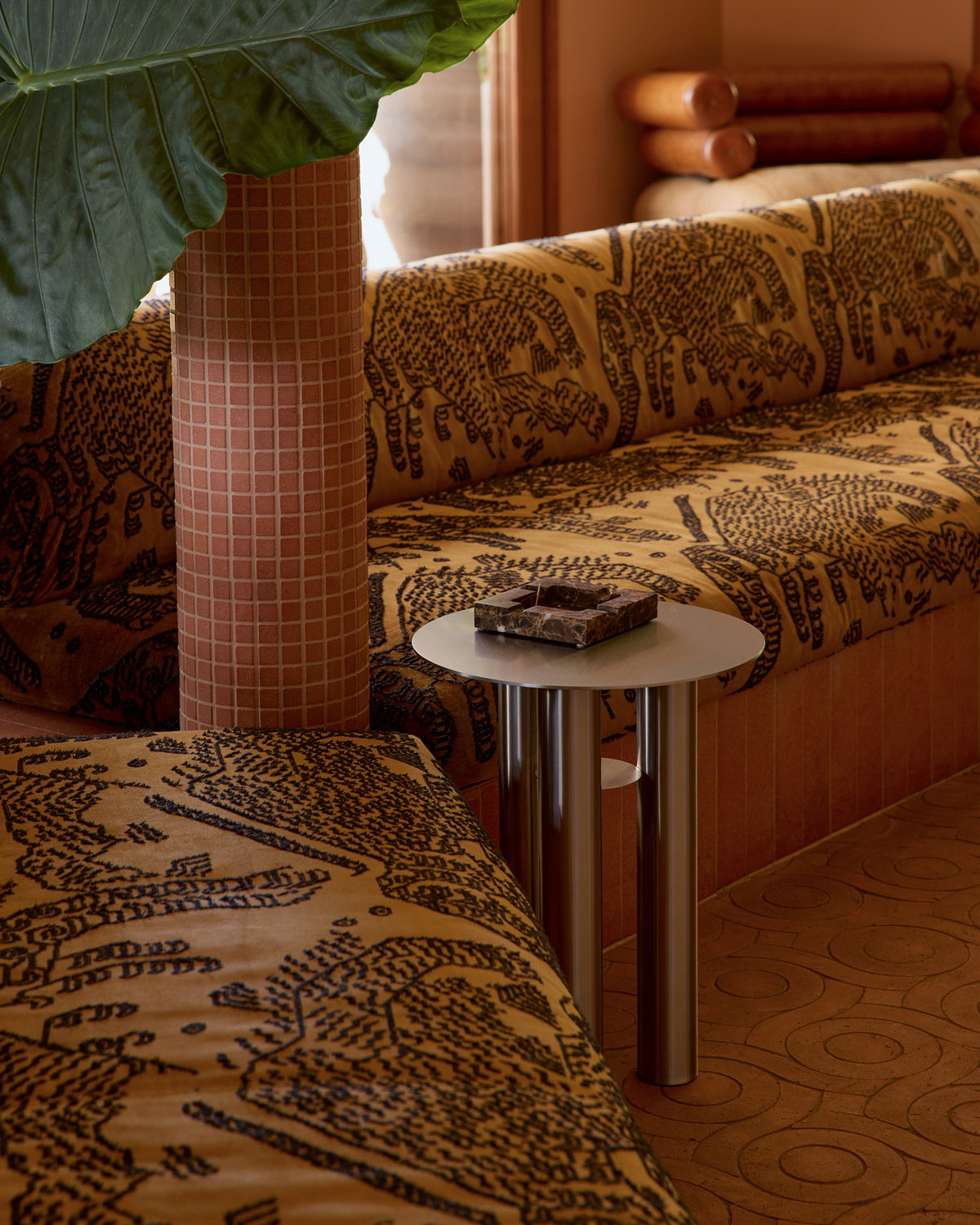 Stainless steel side table styled in a living room.