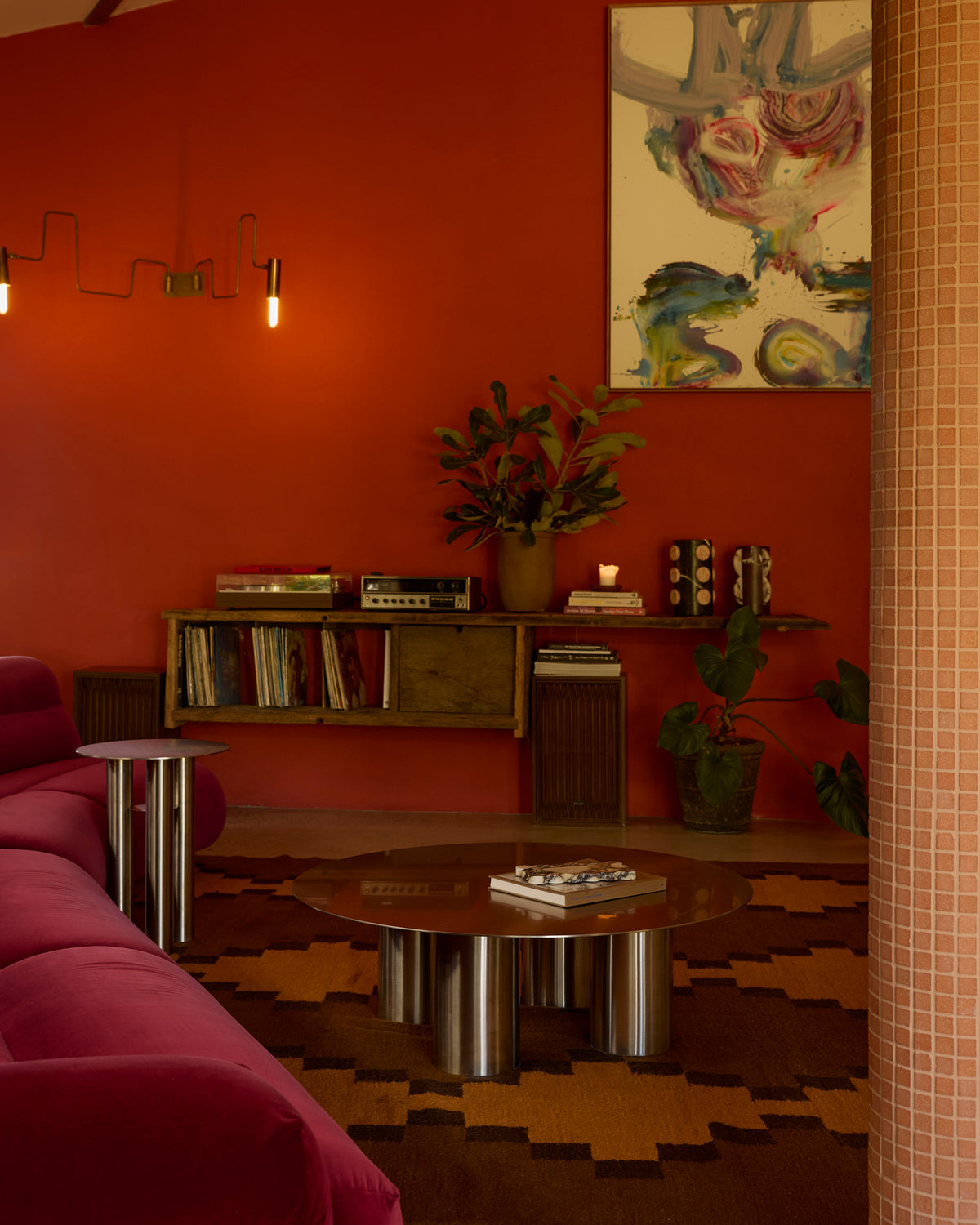 Stainless steel coffee table styled in a colorful living room.