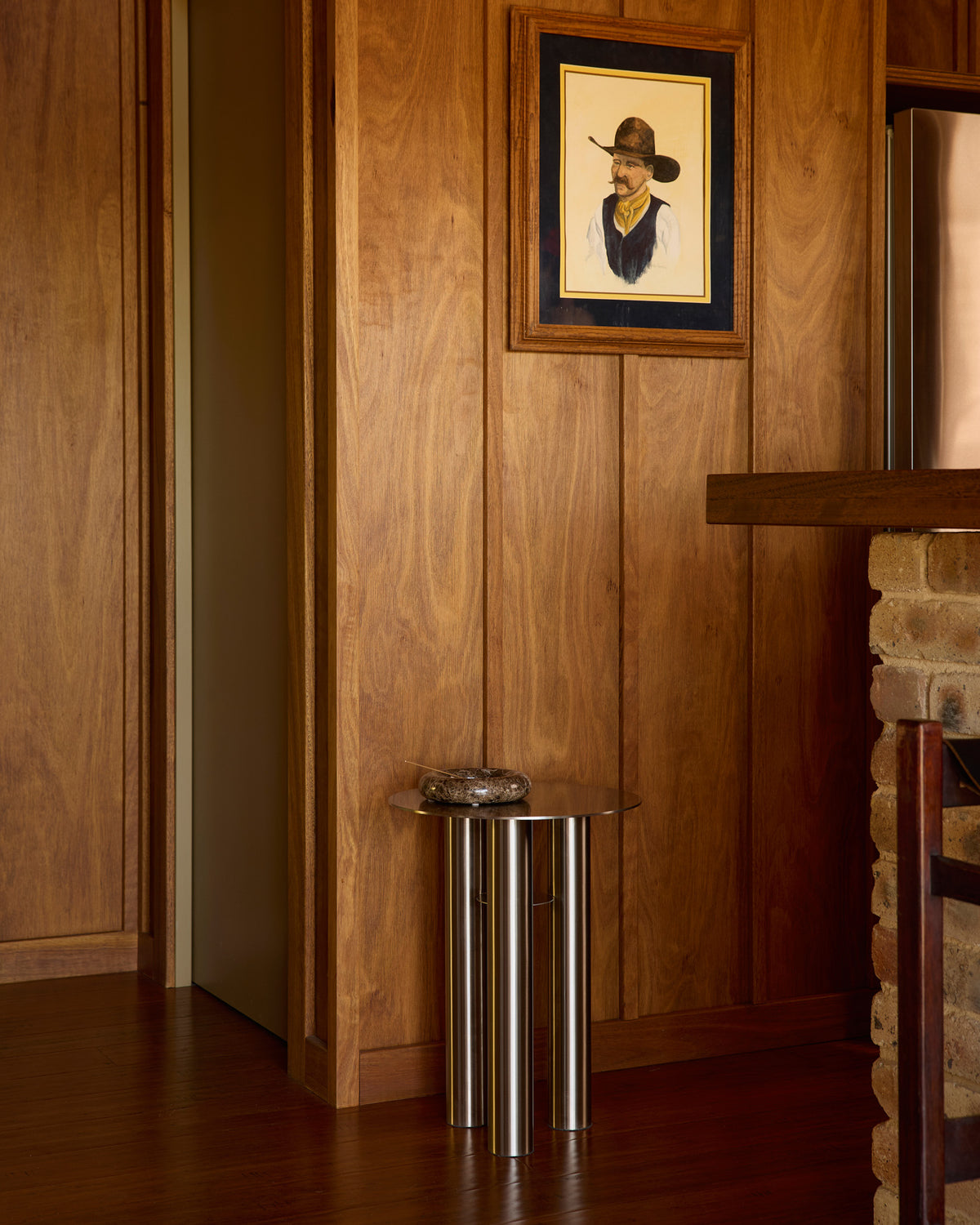 Stainless steel side table styled in a home.