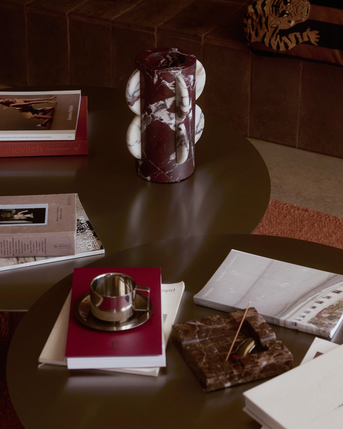 A cylindrical marble vase placed on a coffee table