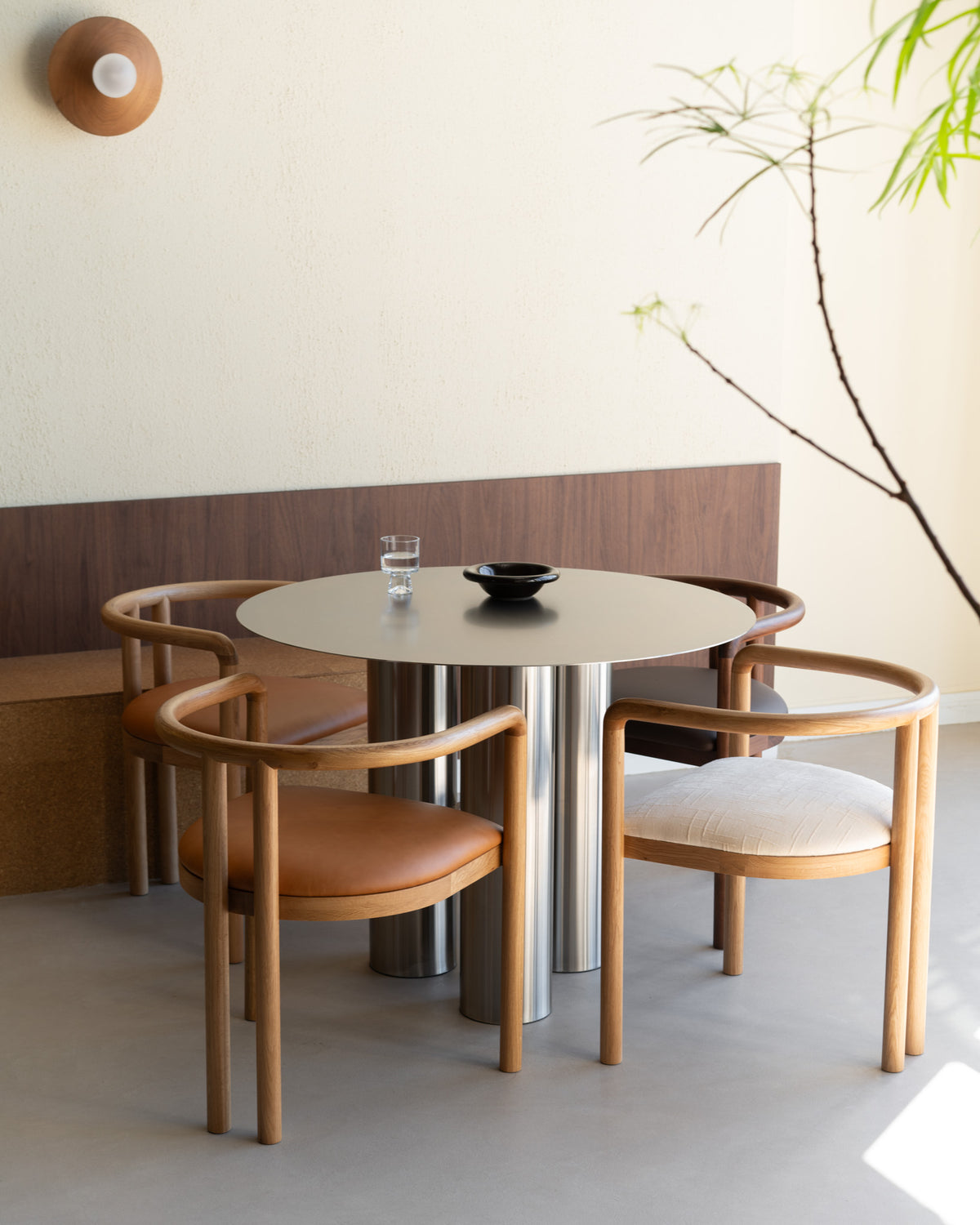Stainless steel dining table with four dining chairs.