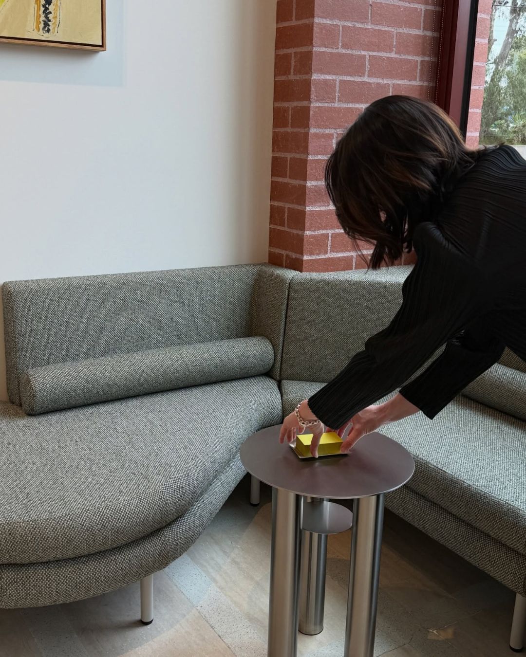 Stainless steel side table next to a sofa