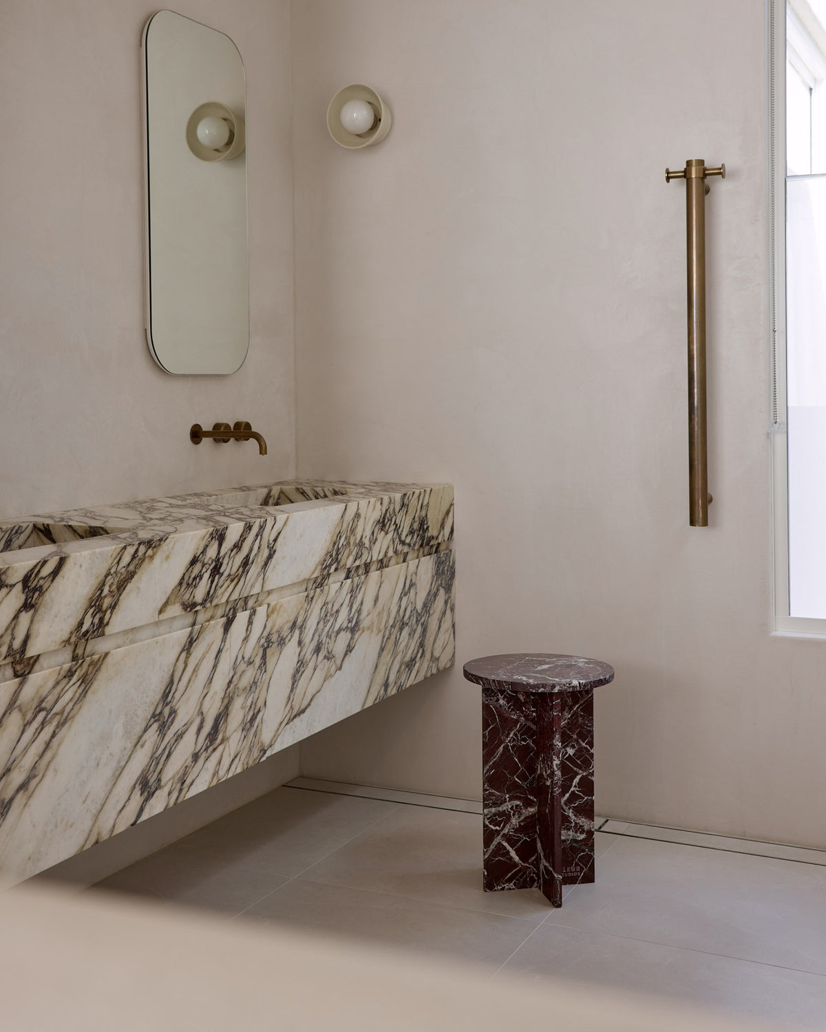 Rosa levanto marble side table in a bathroom