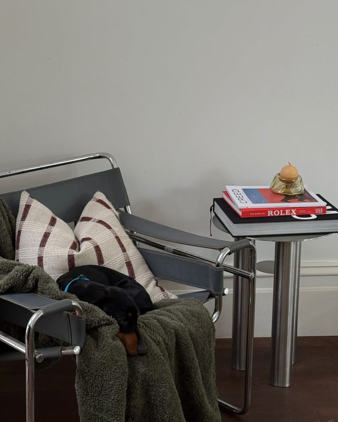 Stainless steel side table next to a lounge chair