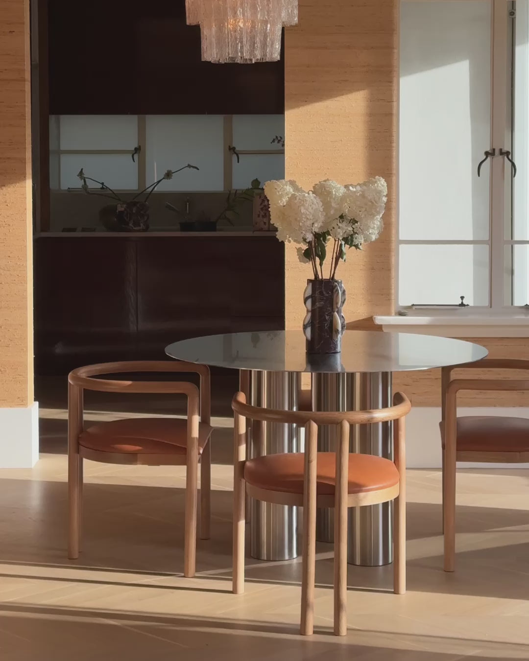 Stainless steel dining table styled in a home.