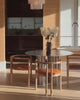 Stainless steel dining table styled in a home.